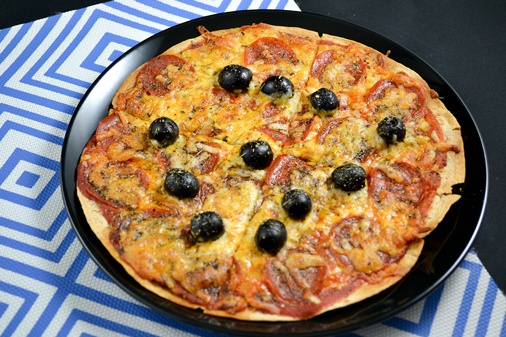 This low carb pizza is the perfect lunch or dinner when you are craving pizza! With the use of low carb tortillas, you are able to dress up your pizza however you want and quickly get this meal into the oven. The tortilla gets crispy on the bottom, giving you that delicious thin pizza feeling. 