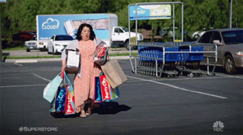 GIF of a woman with tons of shopping bags