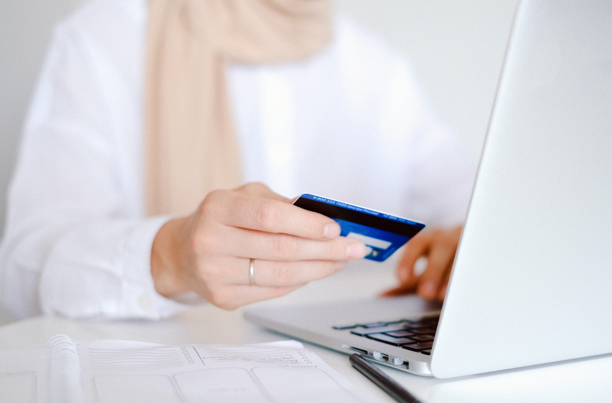 A woman holding a card as she shops on WooCommerce