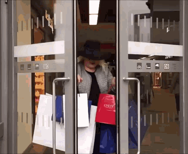 GIF of a woman opening a door after shopping